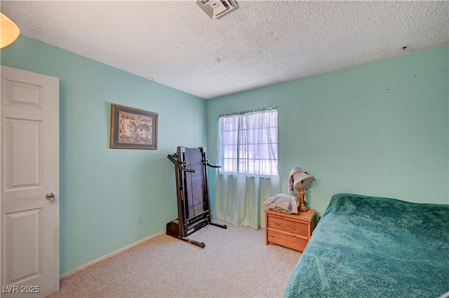 bedroom with carpet flooring, visible vents, and a textured ceiling