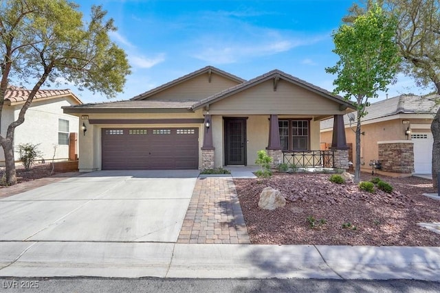 view of front of house featuring stucco siding, covered porch, driveway, an attached garage, and a tiled roof