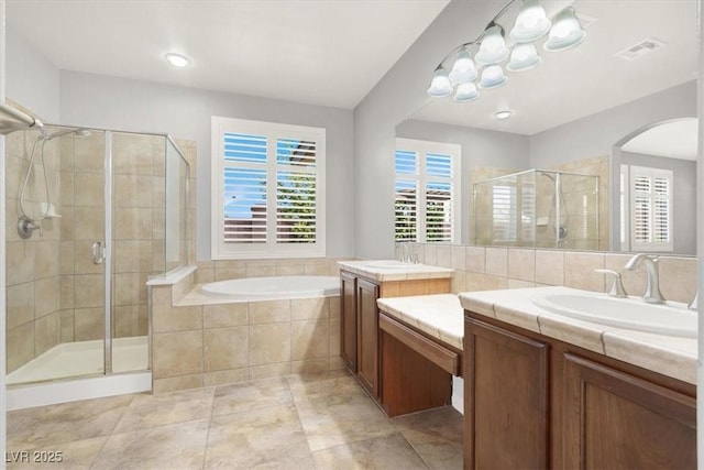 7806 Sundial Peak St, Las Vegas, NV 89166 - full bath with a stall shower, two vanities, a garden tub, and tile patterned flooring