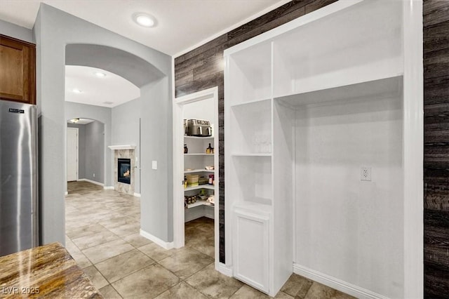 7806 Sundial Peak St, Las Vegas, NV 89166 - hall featuring arched walkways and light tile patterned floors