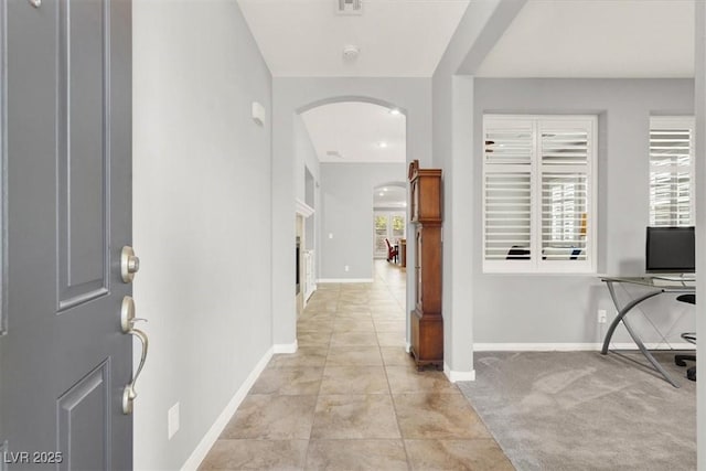 7806 Sundial Peak St, Las Vegas, NV 89166 - foyer entrance with arched walkways, baseboards, and light tile patterned floors