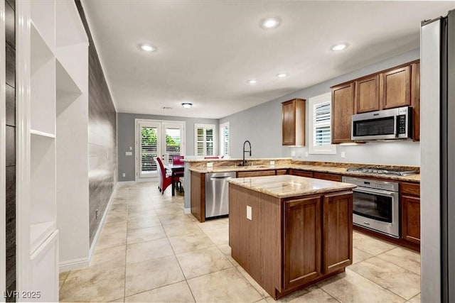 7806 Sundial Peak St, Las Vegas, NV 89166 - kitchen with stainless steel appliances, a peninsula, a sink, a kitchen island, and recessed lighting