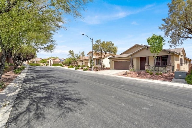 7806 Sundial Peak St, Las Vegas, NV 89166 - view of asphalt road featuring street lighting, a residential view, and curbs