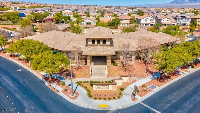 7806 Sundial Peak St, Las Vegas, NV 89166 - view of front of property featuring a residential view, stone siding, a tiled roof, and a mountain view
