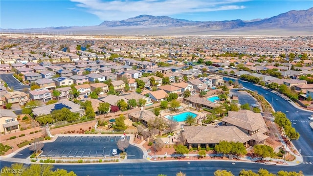 7806 Sundial Peak St, Las Vegas, NV 89166 - aerial overview of property's location with a mountain backdrop, a pool, and nearby suburban area