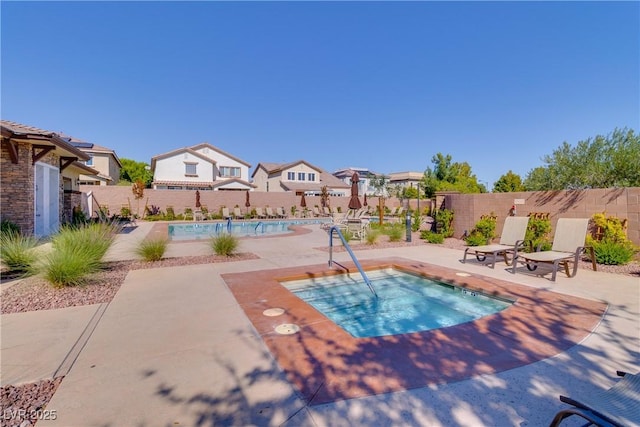 7806 Sundial Peak St, Las Vegas, NV 89166 - community pool with a hot tub, a fenced backyard, a residential view, and a patio