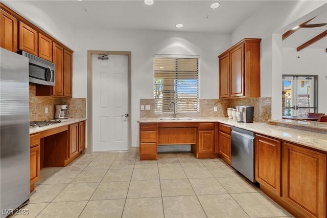 7806 Sundial Peak St, Las Vegas, NV 89166 - kitchen with stainless steel appliances, a sink, decorative backsplash, light tile patterned floors, and brown cabinetry