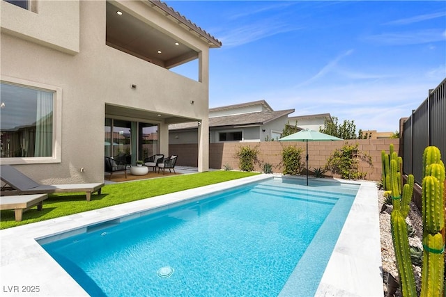 view of swimming pool with a fenced backyard, a fenced in pool, a patio area, and a lawn