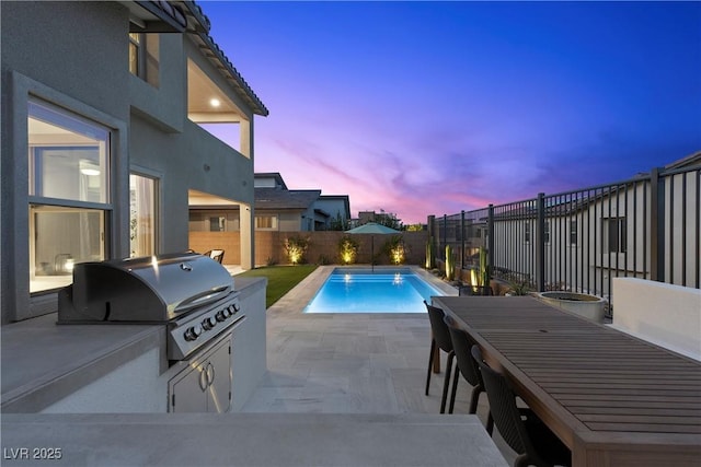 view of pool featuring a fenced in pool, a patio, a grill, area for grilling, and a fenced backyard