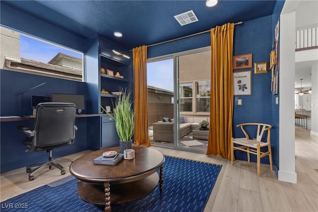 home office featuring wood finished floors, baseboards, visible vents, and recessed lighting