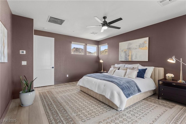 bedroom featuring visible vents, baseboards, and ceiling fan