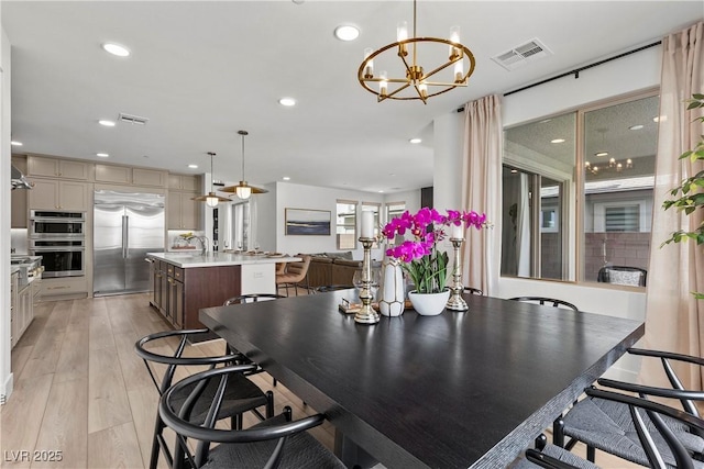 dining space featuring a chandelier, visible vents, and recessed lighting