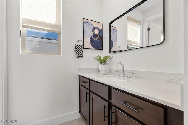 bathroom featuring baseboards and vanity