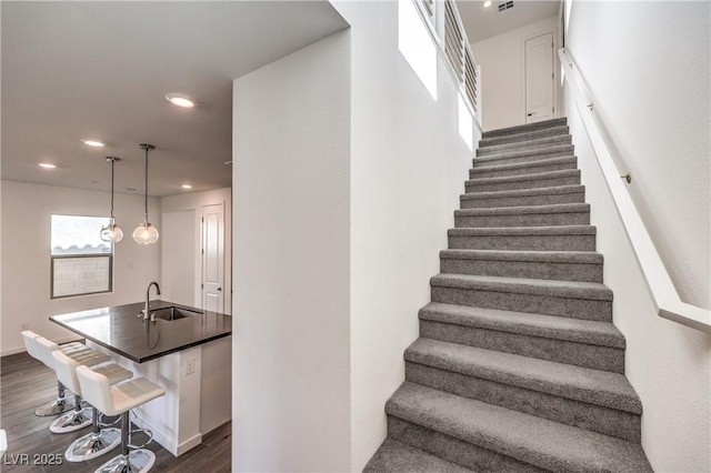 stairs featuring recessed lighting, baseboards, and wood finished floors