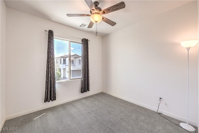 unfurnished room with visible vents, carpet flooring, baseboards, and ceiling fan