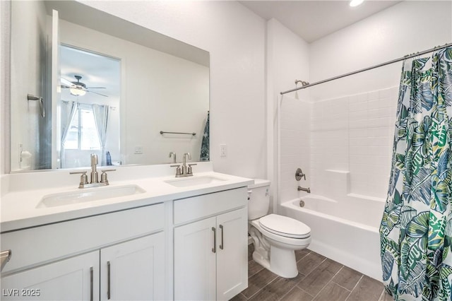 bathroom featuring a sink, ceiling fan, toilet, and wood finished floors