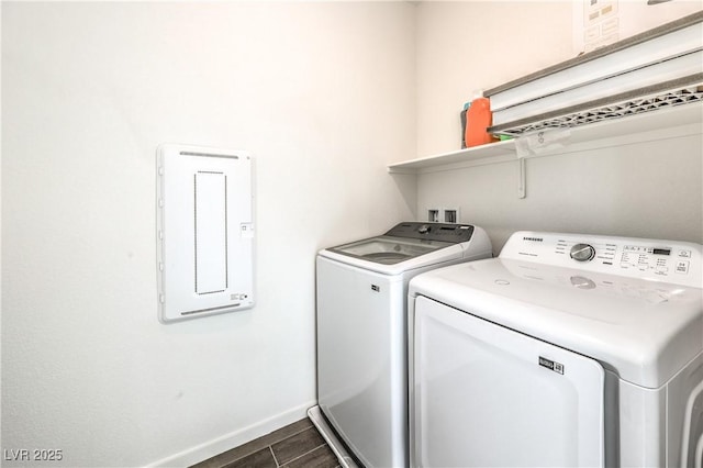 laundry room with laundry area, electric panel, wood finish floors, baseboards, and separate washer and dryer