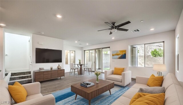 living room with visible vents, stairs, wood finished floors, ceiling fan, and recessed lighting