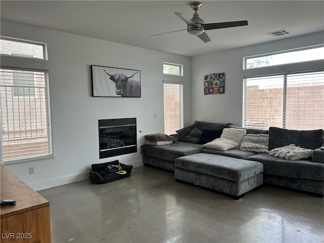 living area with visible vents, ceiling fan, plenty of natural light, and finished concrete flooring