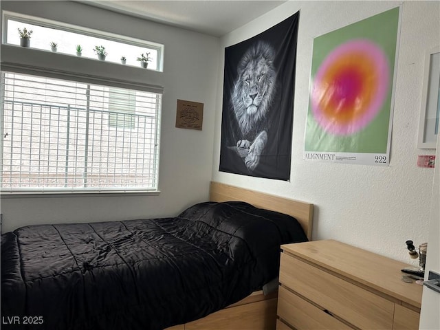 bedroom featuring a textured wall