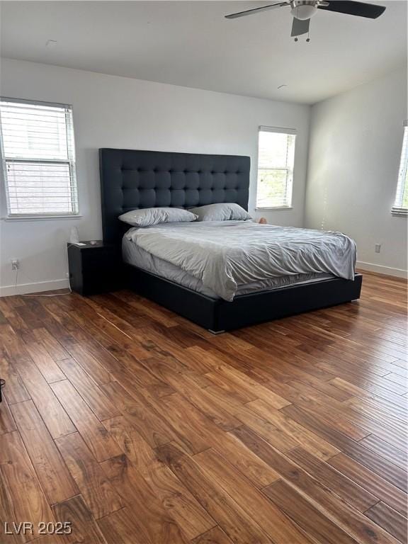 bedroom featuring hardwood / wood-style floors, ceiling fan, and baseboards