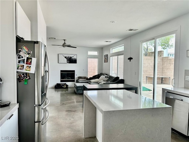 10650 Robin Hill Ave, Las Vegas, NV 89129 - kitchen featuring appliances with stainless steel finishes, finished concrete floors, modern cabinets, white cabinets, and ceiling fan