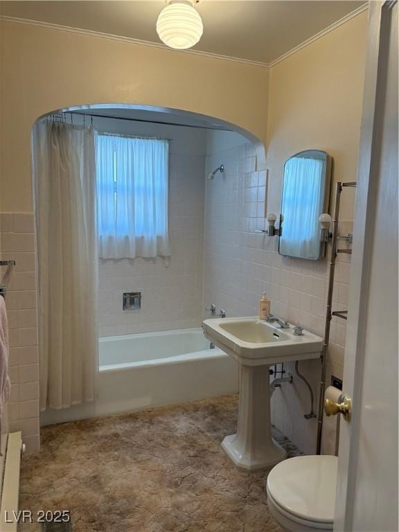 bathroom with shower / bath combination with curtain, tile walls, crown molding, and toilet