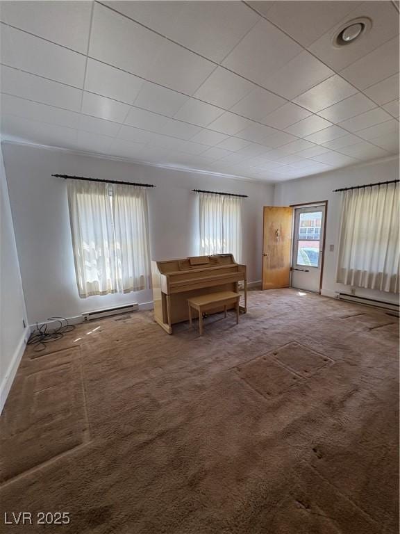 living area with carpet floors, baseboards, and a baseboard heating unit