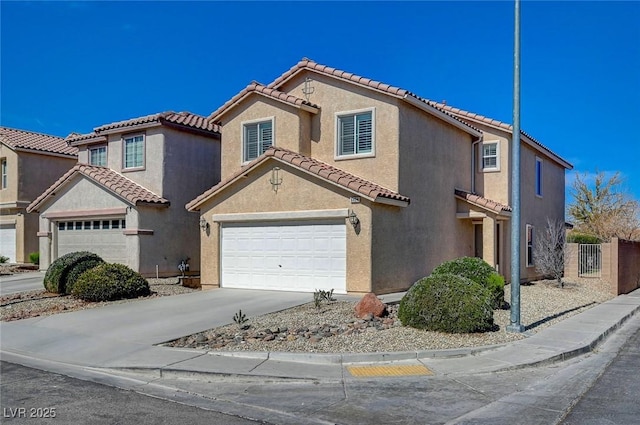 mediterranean / spanish-style home with a garage, a tile roof, fence, concrete driveway, and stucco siding