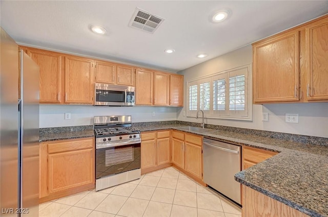 kitchen with recessed lighting, light tile patterned flooring, visible vents, appliances with stainless steel finishes, and a sink