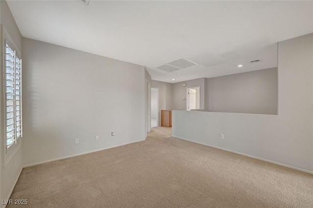 spare room with visible vents, baseboards, recessed lighting, and light colored carpet