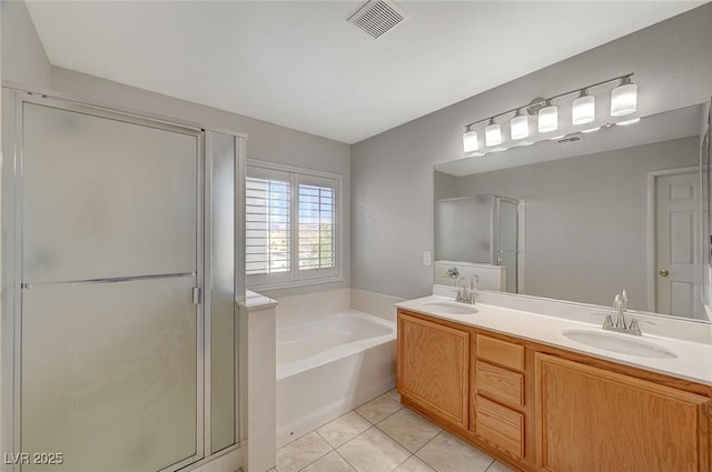 full bathroom featuring a sink, tile patterned flooring, a bath, and a stall shower