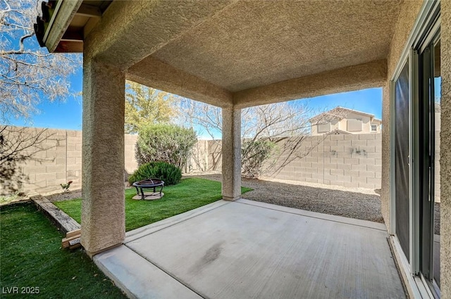 view of patio / terrace with a fenced backyard and a fire pit