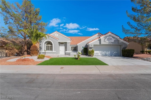 mediterranean / spanish-style house featuring a front yard, a tiled roof, an attached garage, stucco siding, and driveway