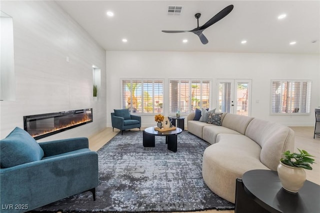 living area with plenty of natural light, a fireplace, visible vents, and recessed lighting