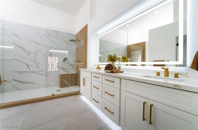 full bathroom with a sink, a marble finish shower, and double vanity