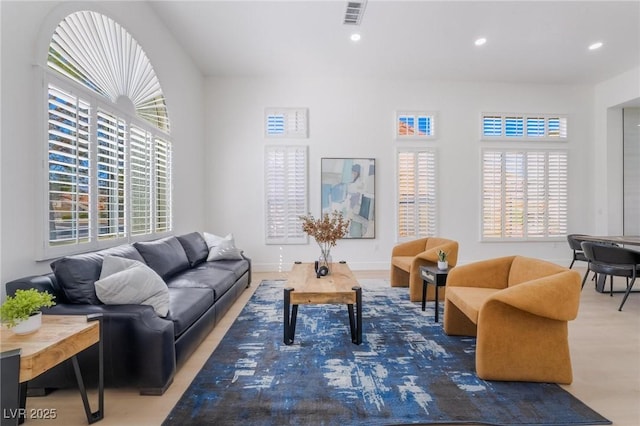 living room with recessed lighting and visible vents