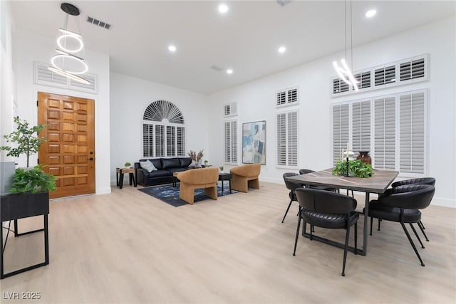 dining space with light wood finished floors, baseboards, visible vents, and recessed lighting