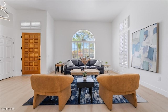 living room with baseboards and wood finished floors
