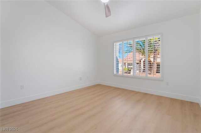 unfurnished room featuring light wood-style flooring, a ceiling fan, baseboards, and lofted ceiling