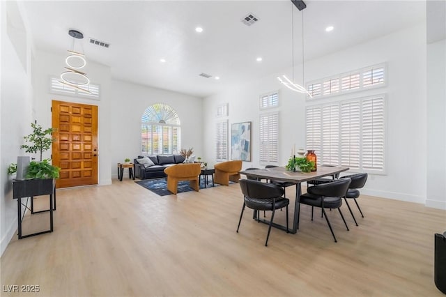 dining space with visible vents, baseboards, and light wood-style floors