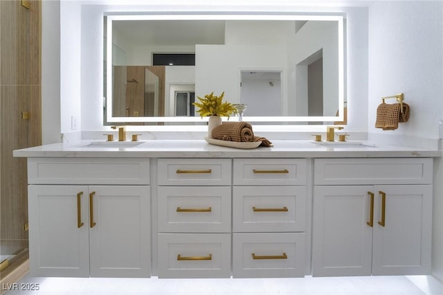 bathroom with a sink, a shower, and double vanity