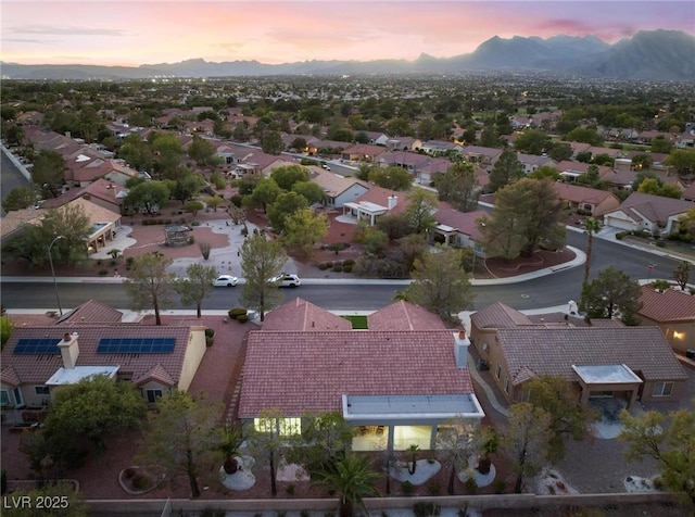 aerial view at dusk with a mountain view and a residential view