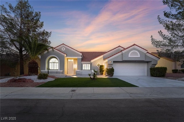 view of front of home with an attached garage, a front lawn, concrete driveway, and a tile roof