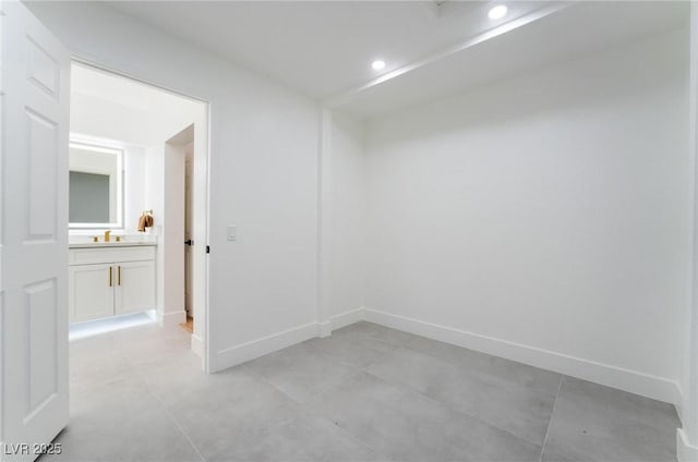 unfurnished room with light tile patterned floors, baseboards, and recessed lighting