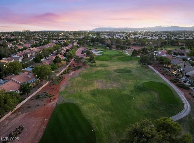 aerial view with view of golf course, a residential view, and a mountain view