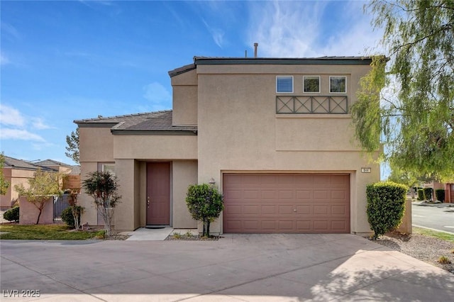 view of front of property featuring concrete driveway, stucco siding, and a garage