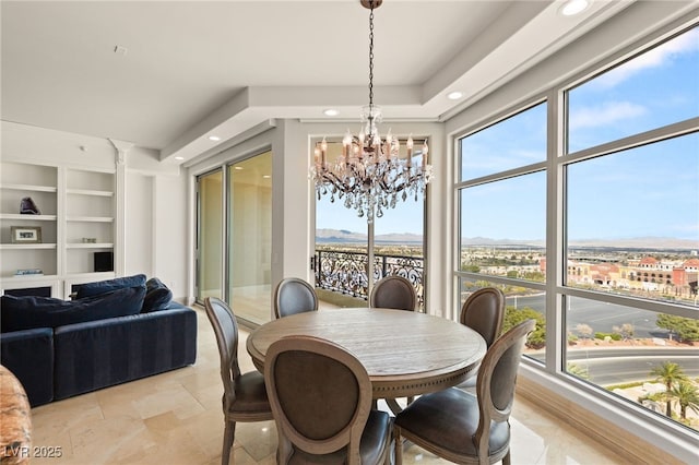 dining area with built in features, recessed lighting, plenty of natural light, and an inviting chandelier