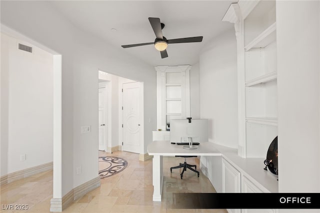 office featuring baseboards, a ceiling fan, and visible vents
