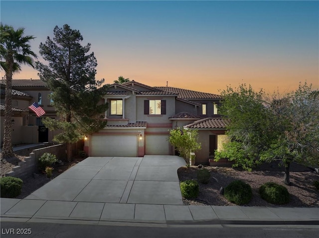 853 Ashford Way, Henderson, NV 89015 - mediterranean / spanish-style home featuring concrete driveway, a tile roof, a garage, and stucco siding